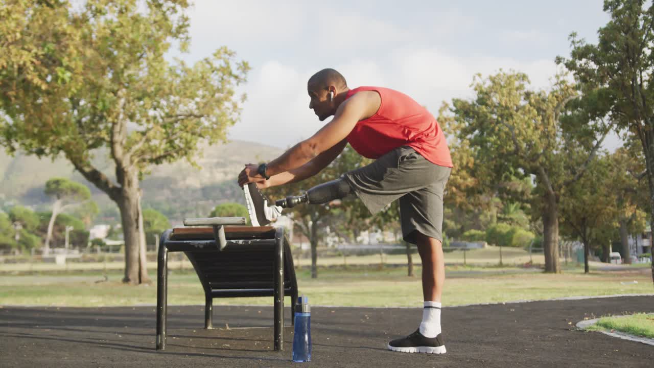 Side view man with prosthetic leg stretching