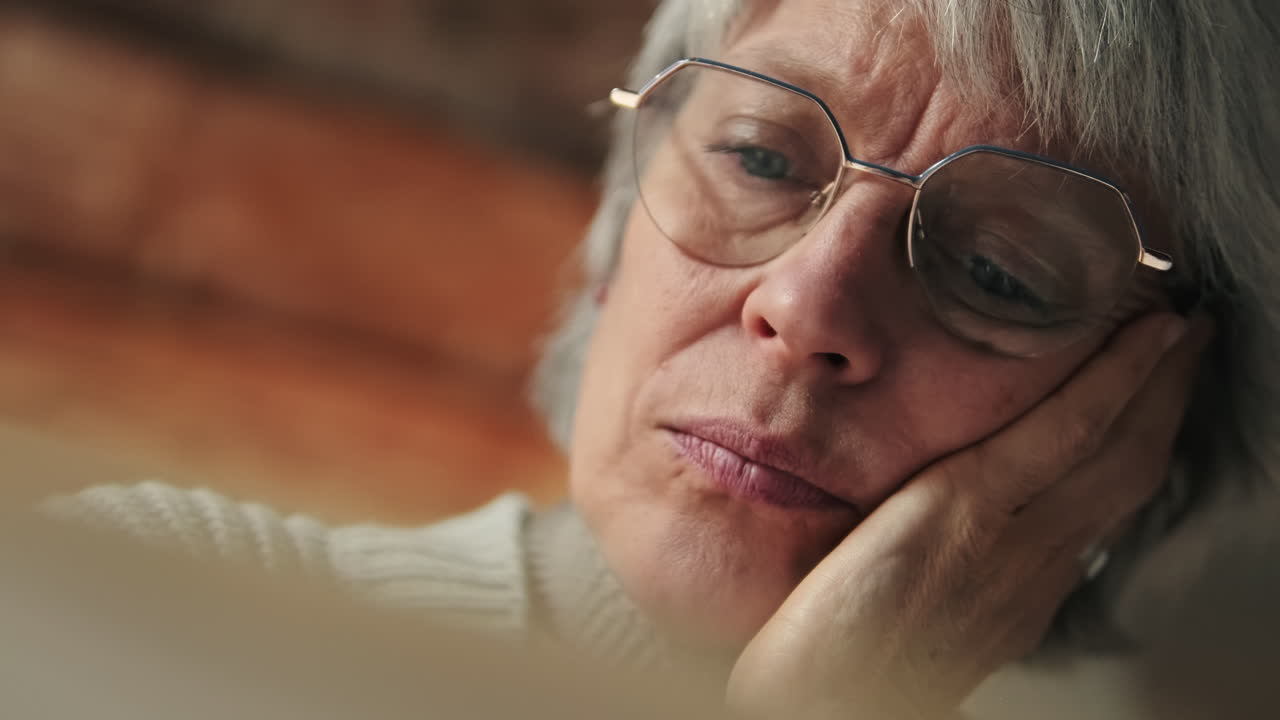 Close-up of a Pensive Senior Woman with Glasses