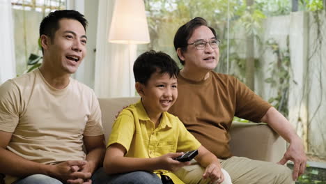 asian men and boy in the living room