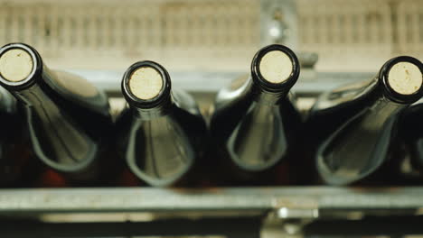 Wine-Bottles-Closed-With-A-Cork-Stopper-Move-Along-The-Conveyor-Belt-View-From-Above