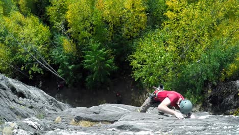 Man-rock-climbing-the-cliff-in-the-forest-4k