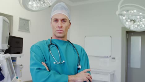 portrait of surgeon standing with arms crossed in operation room