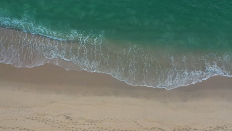 Beach-top-view-with-wave-foam