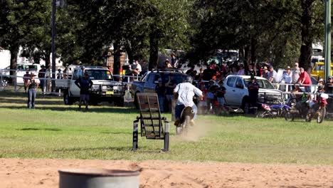 unicyclist jumps over a trash can outdoors