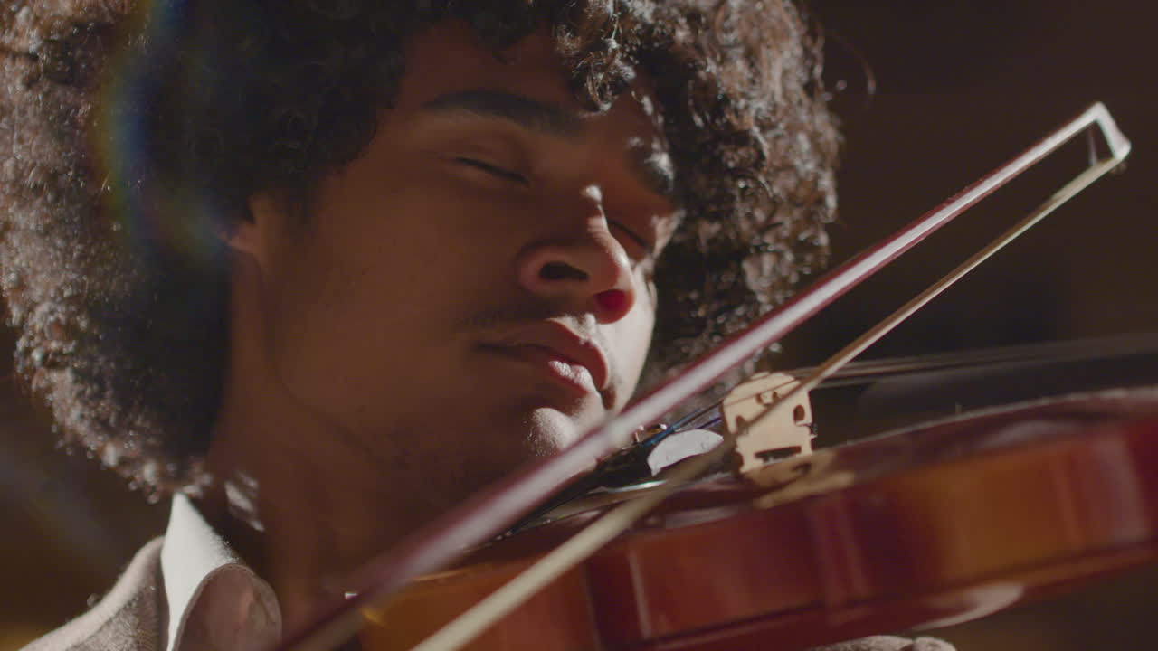 Violinist Playing Music on Stage with Eyes Closed