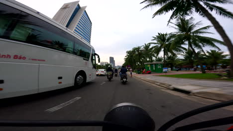 da nang, vietnam - cruising through the city on a scooter with the grand tourane hotel coming into view - pov