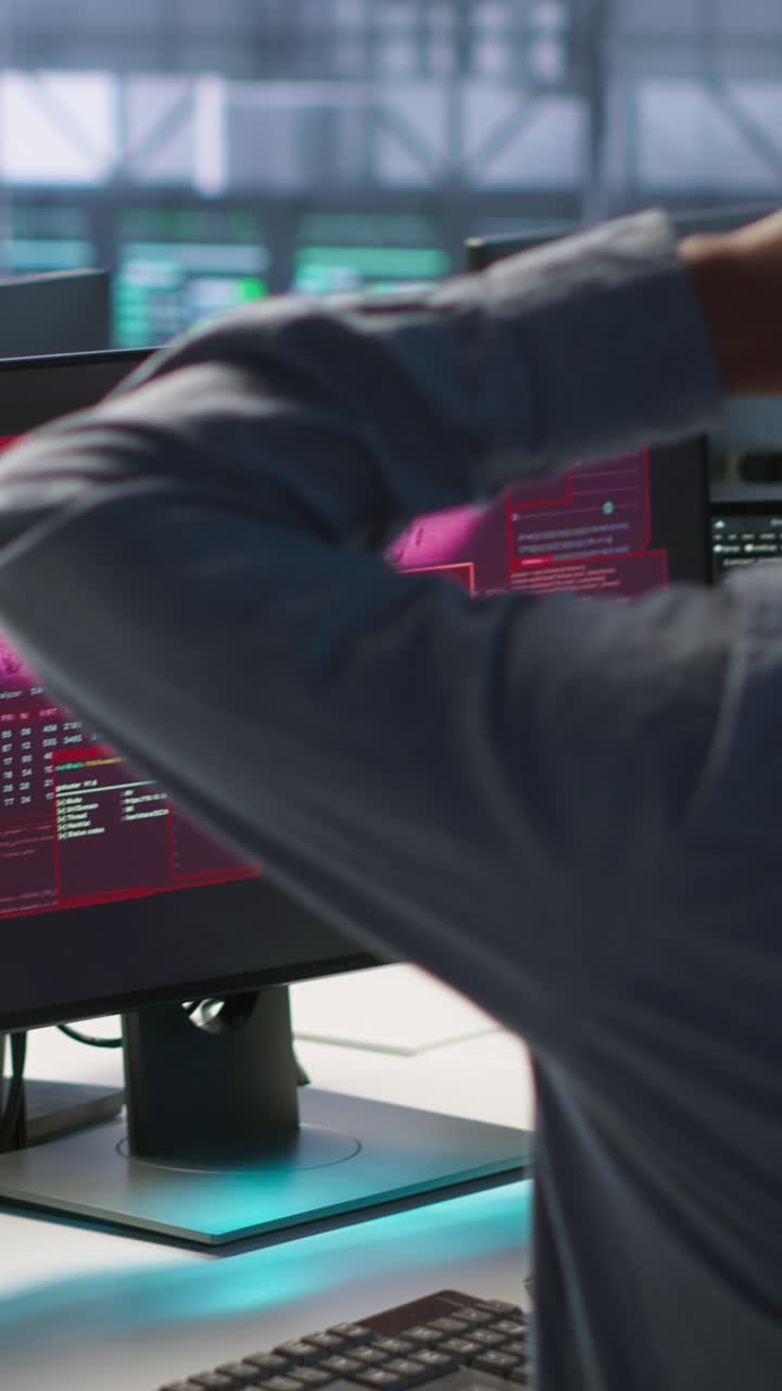 Vertical video Cybersecurity team monitoring security incidents affecting data center