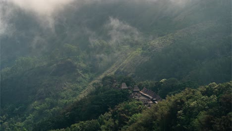 traditional village nestled in a foggy mountain forest