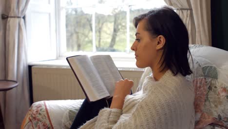 Beautiful-woman-reading-novel-in-bedroom