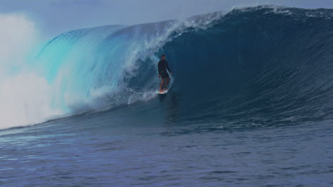 surfer drops in and stands up calmly in slow motion at cloudbreak fiji