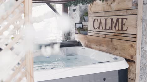 establishing view of an outside hot tub and jacuzzi located in an air bnb rental apartment in the french pyrenees