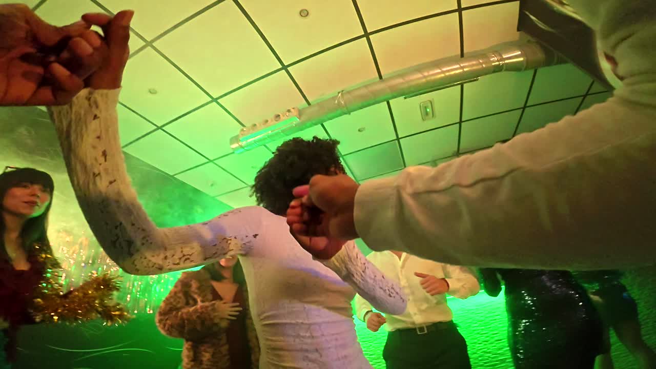 Energetic Friends Dancing and Celebrating at a Nightclub Party