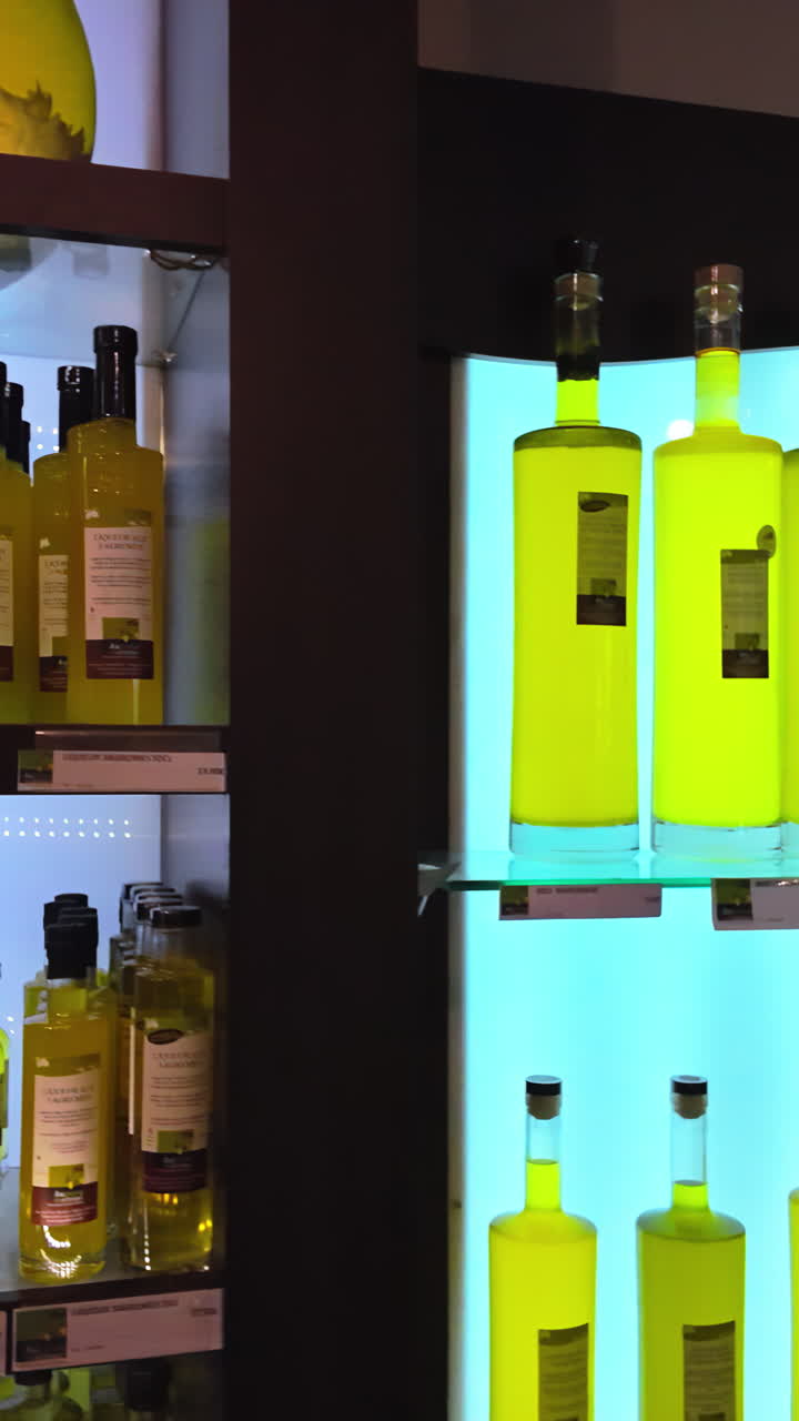 Close up of bottles of limoncello in a store in Menton, France. Vertical