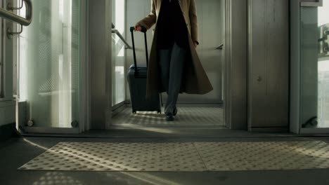 woman traveling with luggage in airport/elevator