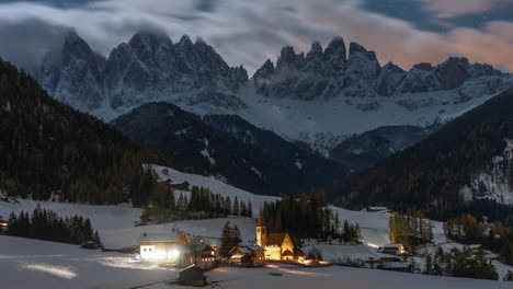 Cinematic-starry-time-lapse-Italia-Dolomites-Dolomiti-Val-di-Funes-Italy-first-snowfall-early-winter-late-autumn-fall-clouds-St-Maddalena-Magdalena-Catholic-Church-iconic-photographed-still-Bolzano