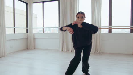 artistic girl looking at camera and performing contemporary dance
