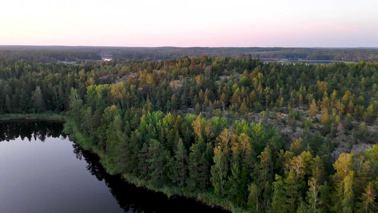 Finnish lake-and-forest landscape on a summer evening in an aerial drone view
