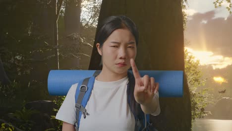 woman hiking, pointing, and rejecting