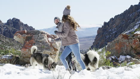 a young couple having a snowball fight