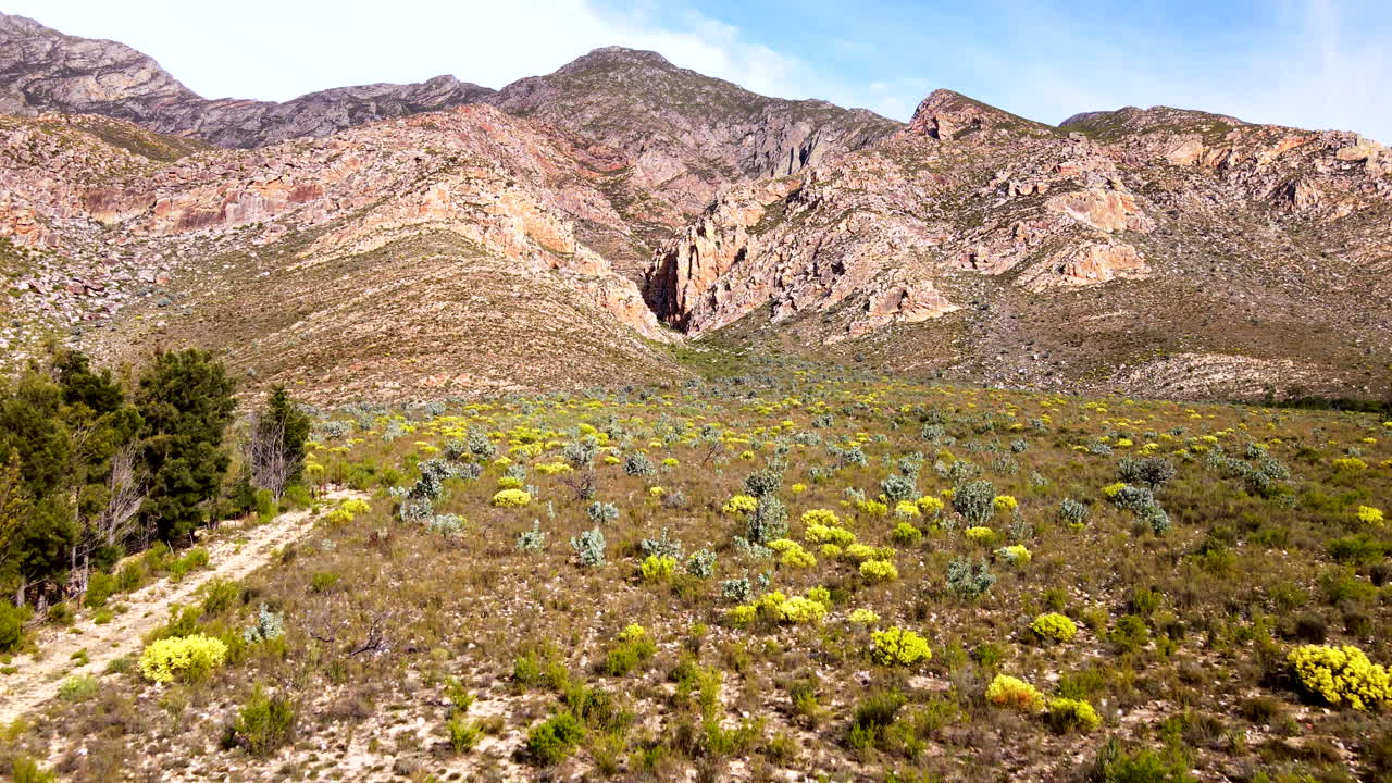 Aerial approach shot toward rugged rocky Langeberg mountain in Klein Karoo