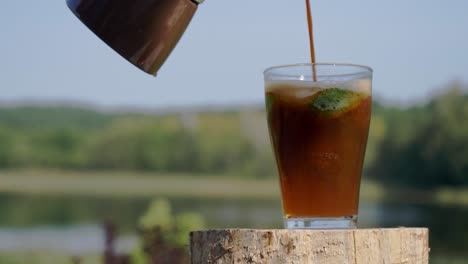 Making-Espresso-Tonic---Pouring-Espresso-Into-A-Glass-With-Tonic,-Ice,-And-Slices-Of-Lime---close-up,-selective-focus