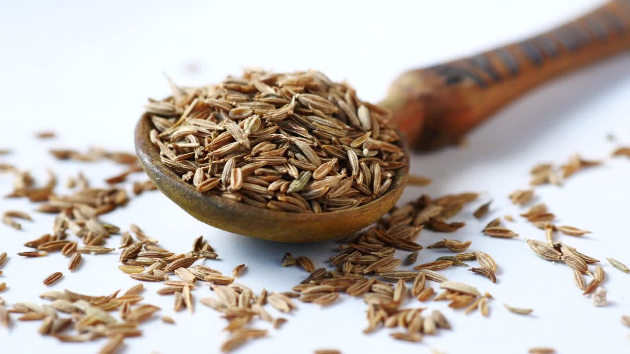 Cumin Seeds in a Wooden Spoon