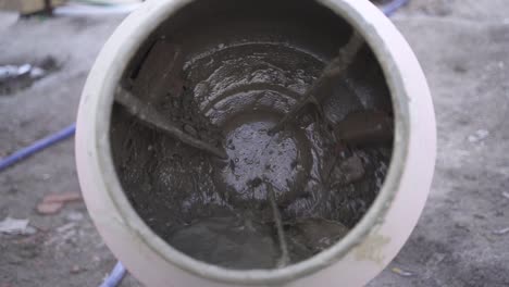 Slow-motion-shot-of-concrete-cement-mixer-rotating-on-construction-site,close-up