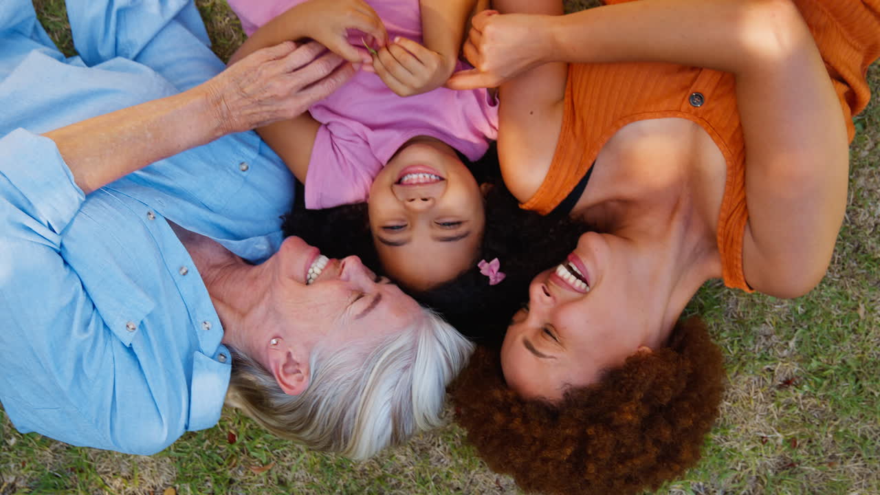 잔디 위에 누워있는 다세대 여성 가족의 오버헤드 초상화  손녀