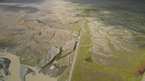 Aerial-view-of-Icelandic-meadow-looking-like-braids,-warmed-up-by-sunny-day