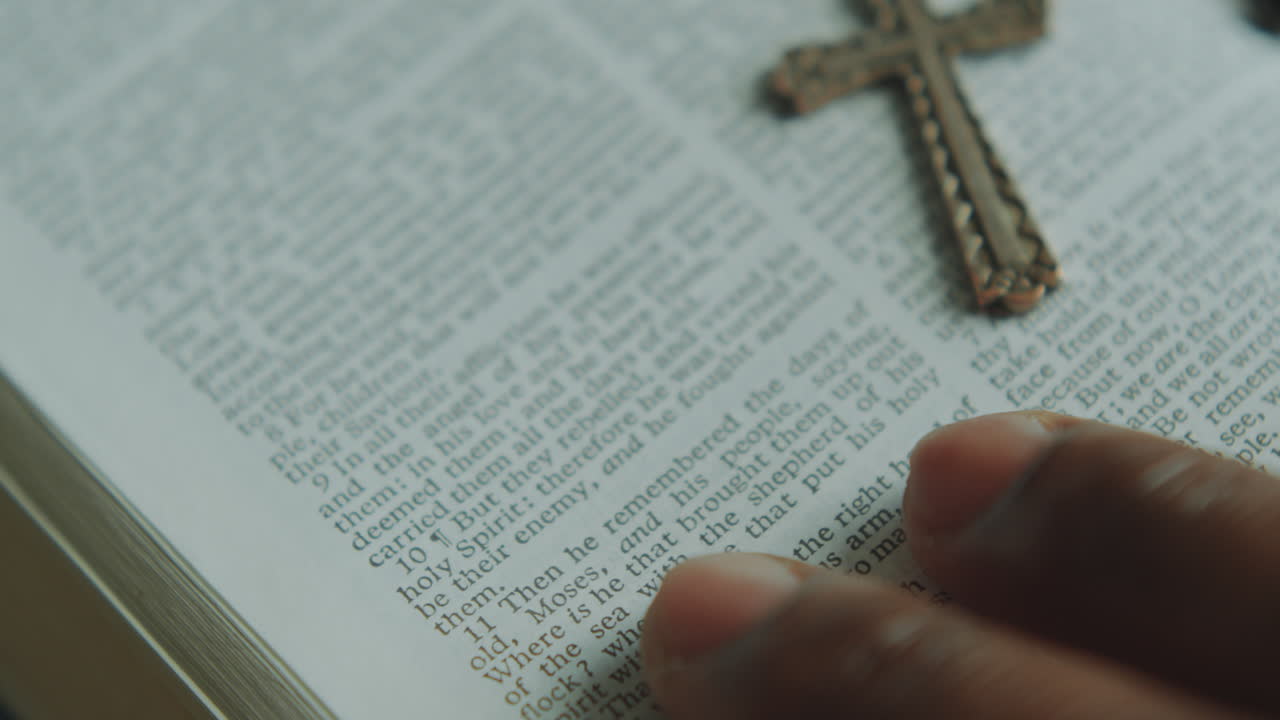 Hand on Man Reading Religious Text in Holy Bible