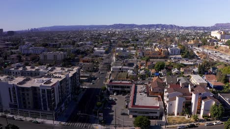 aerial reverse pull-back shot of echo park with hollywood in the background