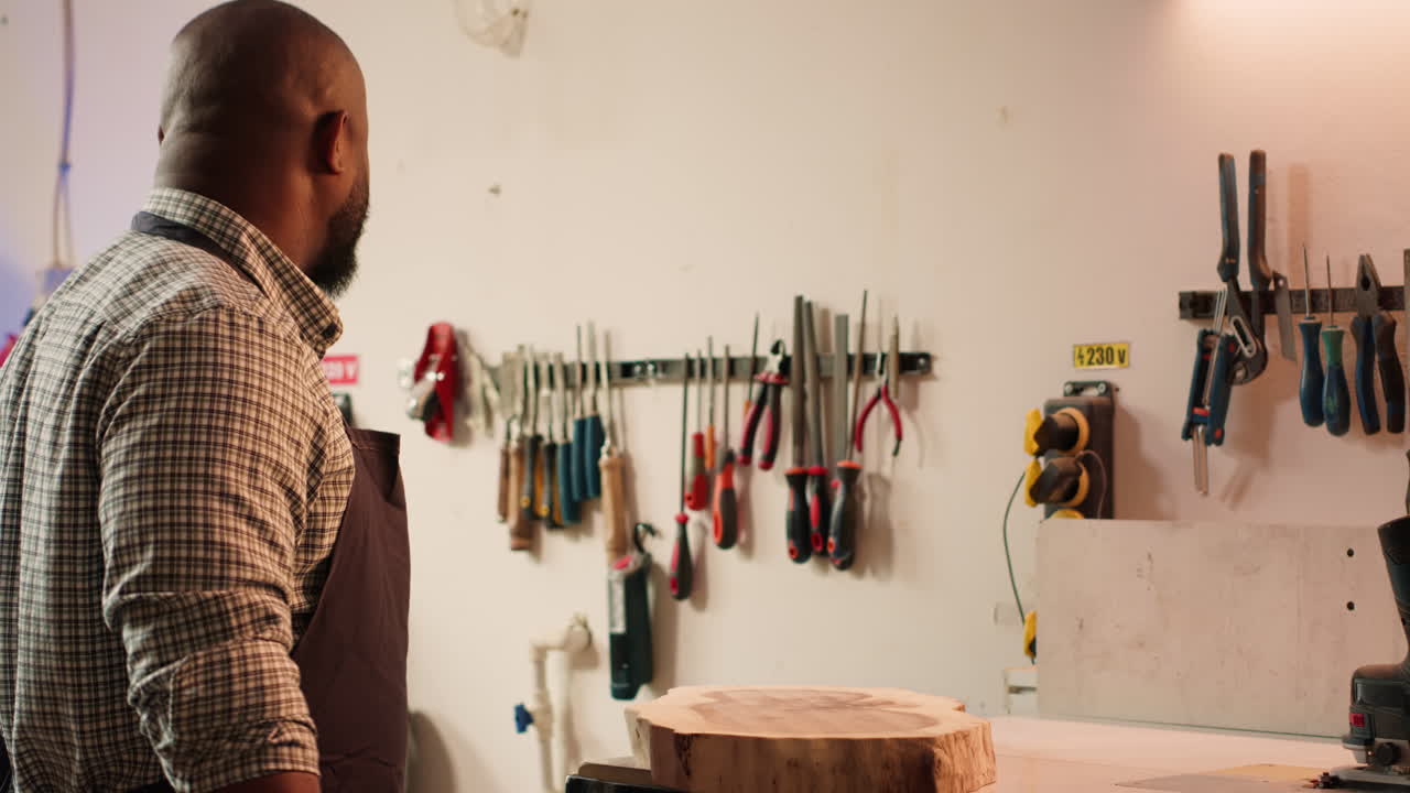Cabinetmaker picking lumber block, preparing to do piling on it