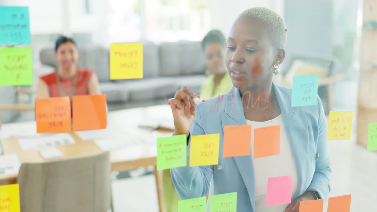 Black woman writing, team or sticky notes