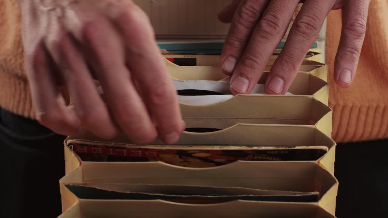 Man hands browsing vintage vinyl records in special bag close-up. Searching music. Musical shopping. Retro Vinyl record player. High quality 4k footage