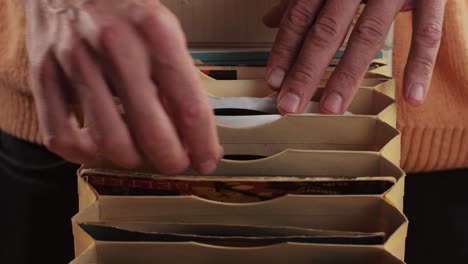 man hands browsing vintage vinyl records in special bag close-up. searching music. musical shopping. retro vinyl record player. high quality 4k footage