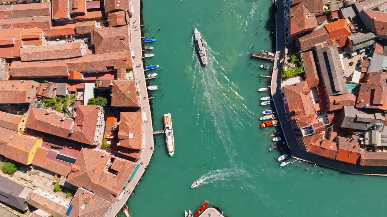 Boats moving on a canal in Murano, Venice, Italy