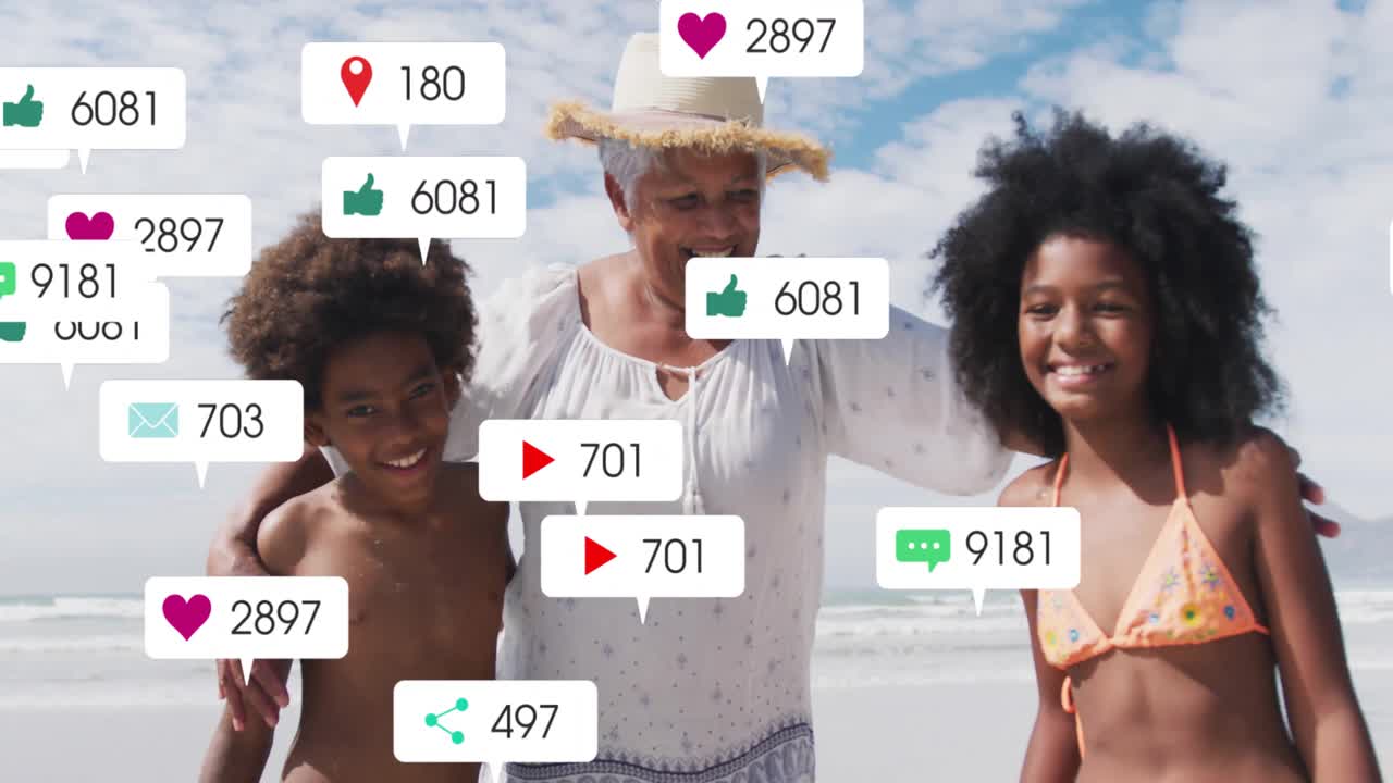 Senior woman walking grandchildren on shoreline, social media notifications popping, boosting reach