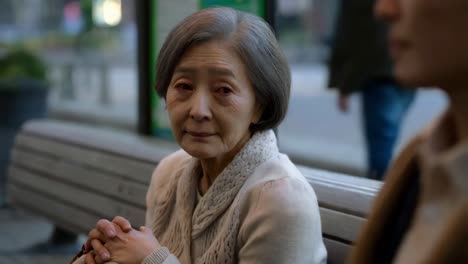 elderly woman sitting on a bench