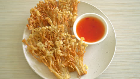 deep fried enoki mushroom or golden needle mushroom with spicy dipping sauce - vegan food style