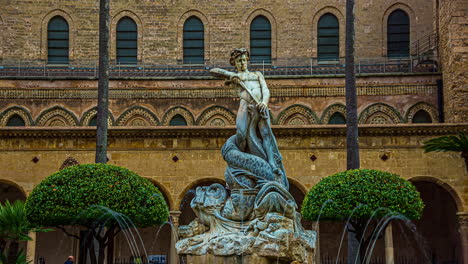 Monreale,-Italy--Historical-statue-in-front-of-Cathedral-of-Monreale-near-Palermo-in-Sicily,-Italy-with-tourists-passing-by-ata-daytime-in-timelapse