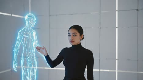 a woman interacting with a holographic projection of a human body