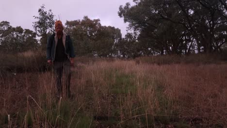 fishermen walking towards camera in a dry creek bed in outback australia