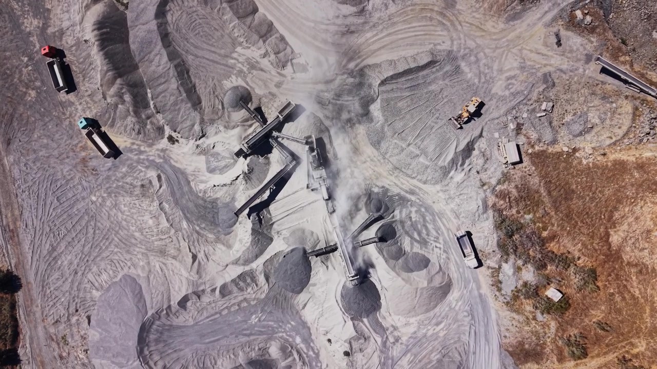 Construction site with machinery and materials in a dry area