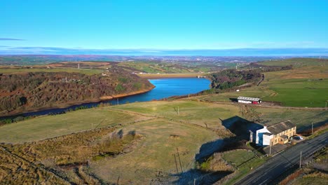 winter aerial footage scene of scammonden reservoir with the m62 motorway bridge