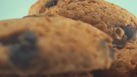 a macro close up shot of a white plate full of delicious chocolate chip cookies, on a 360 rotating stand, studio lighting, slow motion, 4k video