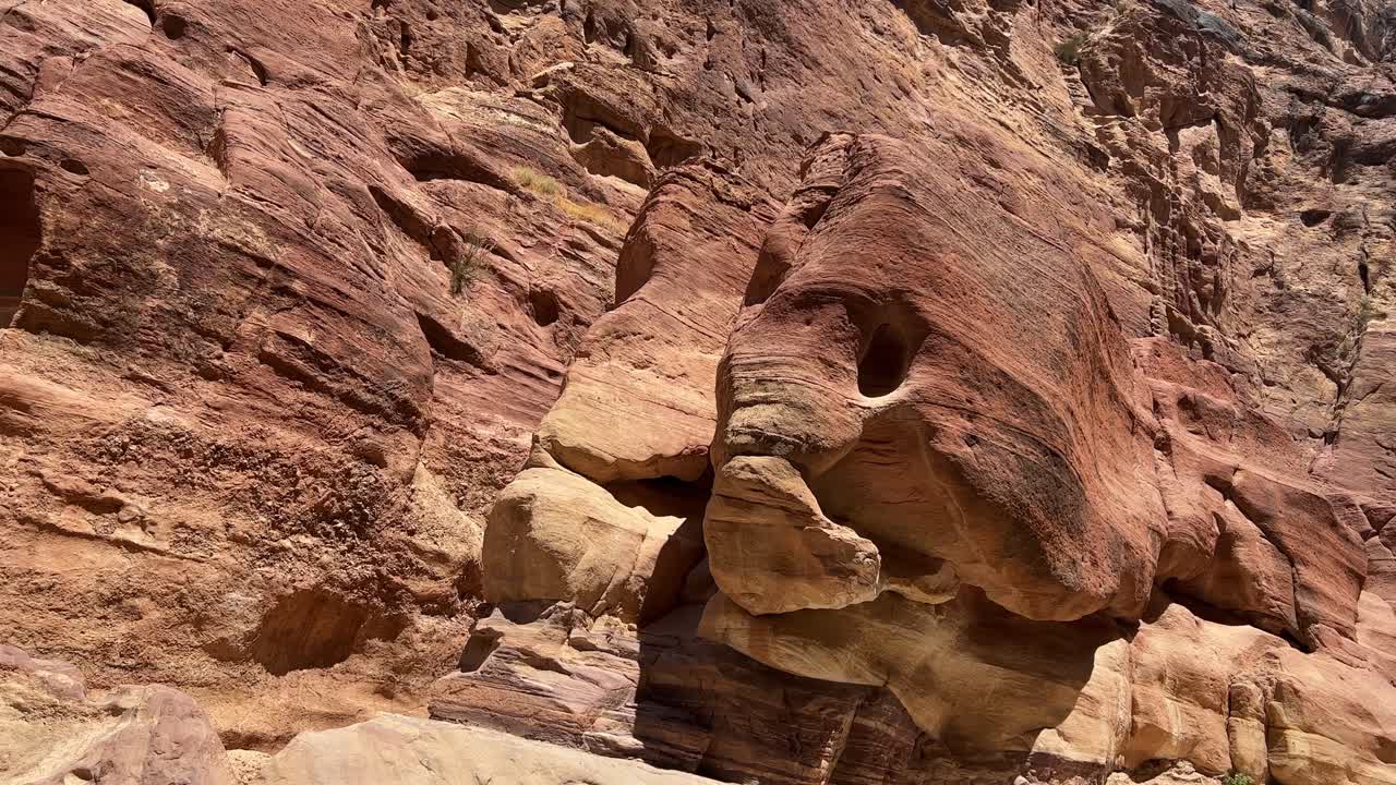 Petra valley in Wadi Musa, Jordan with The Treasury in the middle of a rocky and mountainous landscape, an UNESCO heritage site, ancient Nabatean Kingdom 4K Establish Shot