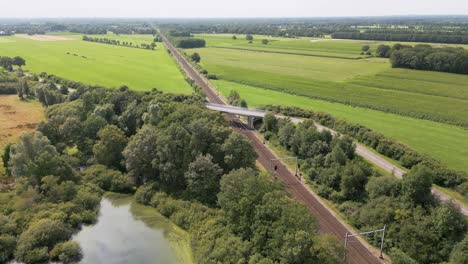 aerial view of railroad crossing in dutch countryside