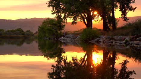 Reflection-of-sunset-over-lake-surface-during-wildfires-of-late-August-2020-in-Colorado