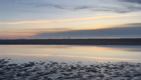 silhouette of a couple walking down the peaceful oregon coast