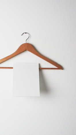 vertical video of book on hanger with white blank pages and copy space on white background
